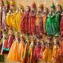 multicolored puppets hanged up to a wall in Jaisalmer rajasthan